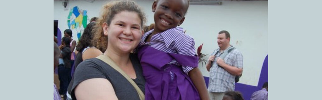 Annie holidng Ghanian child