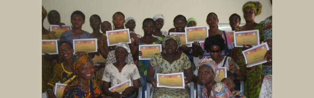 Christiana Yaghr presents certificates to women with disabilities who completed the HIV/AIDS training.
