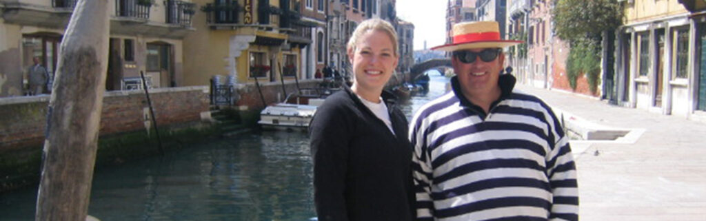 Loren stands next to a gondola operator during an excursion in Venice.