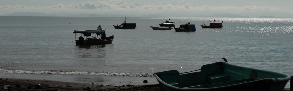Boats are out in the water and along the beach in Costa Rica.
