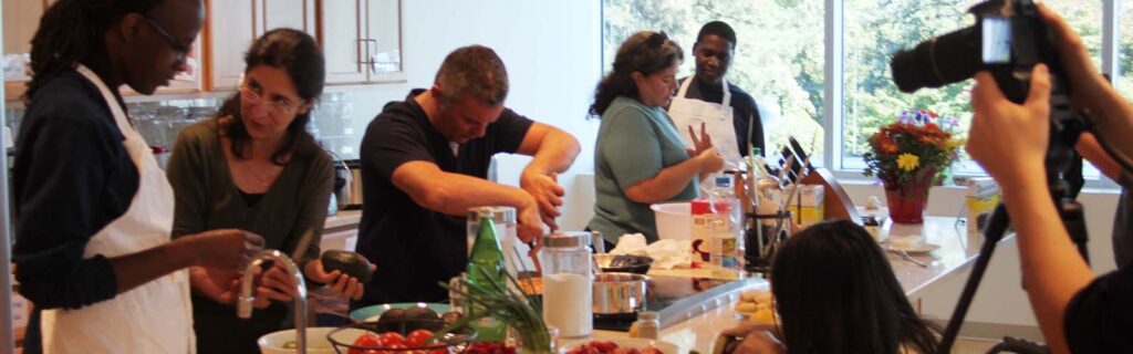 Team Serbia lined up behind a counter of food