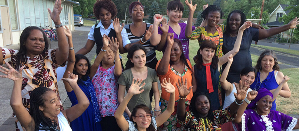 Group of diverse women raising their arms in unison