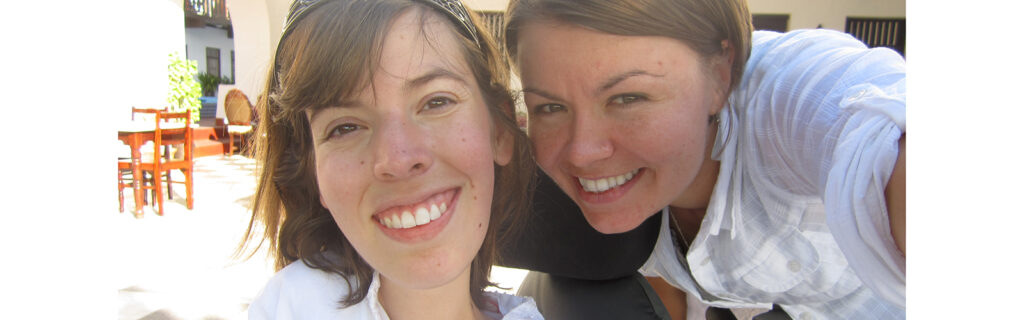 Close up of two young women smiling.