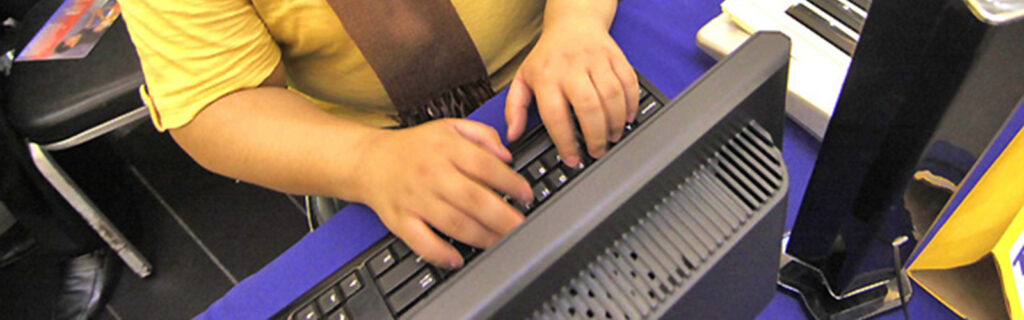 Hands typing on a computer keyboard