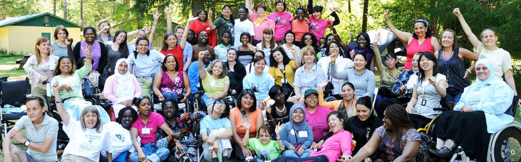 Group shot of WILD women and MIUSA staff yelling with arms in the air