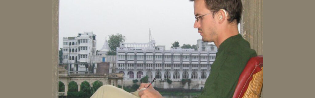 Franz Knupfer, who has a cochlear implant, sits in a window overlooking in Udaipur Rajasthan, India