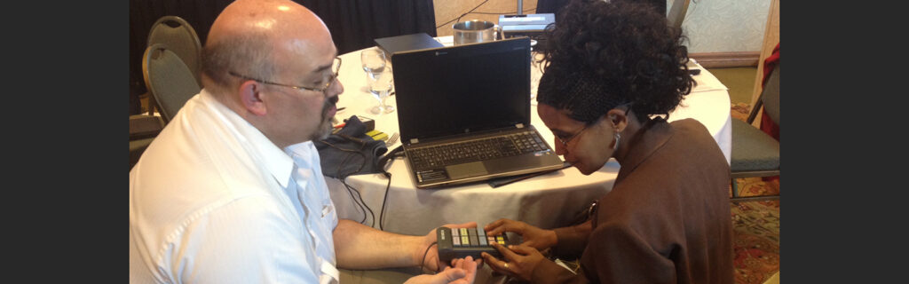 Blind woman from Ethiopia using adaptive voting device