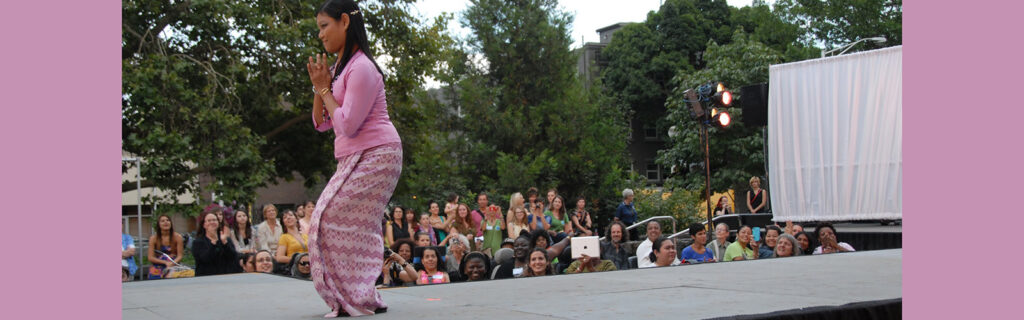 A woman from Myanmar, who has cerebral palsy, bowing in a fashion show in traditional dress