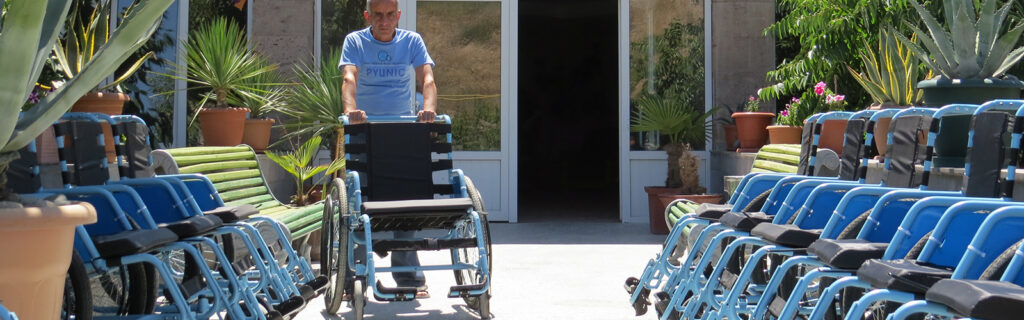 Employee at Pyunic pushes manual wheelchair