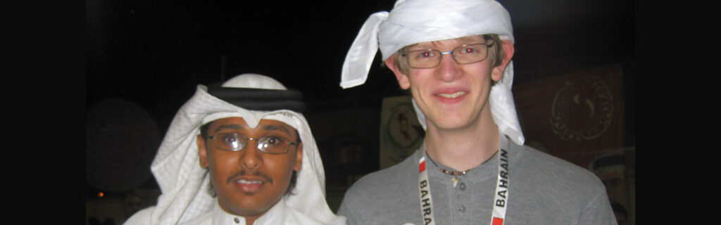 Bahraini and American young men wearing traditional head scarves