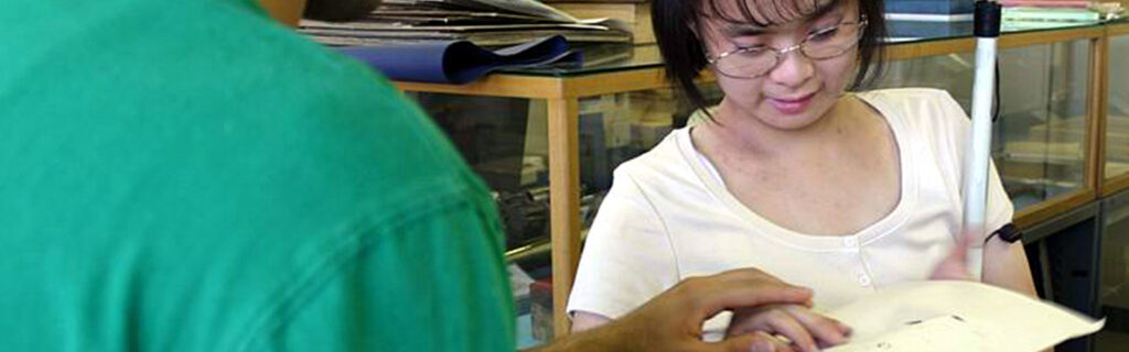 Blind woman feels a braille embossed document