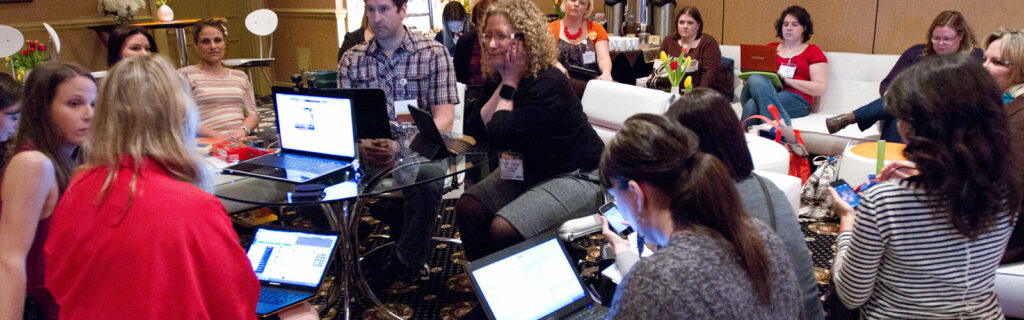 A group of women and men on laptops