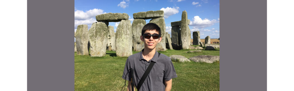 Danny standing in front of Stonehenge in England.
