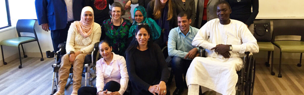 Group photo of people from different countries with different disabilities, many in traditional dress