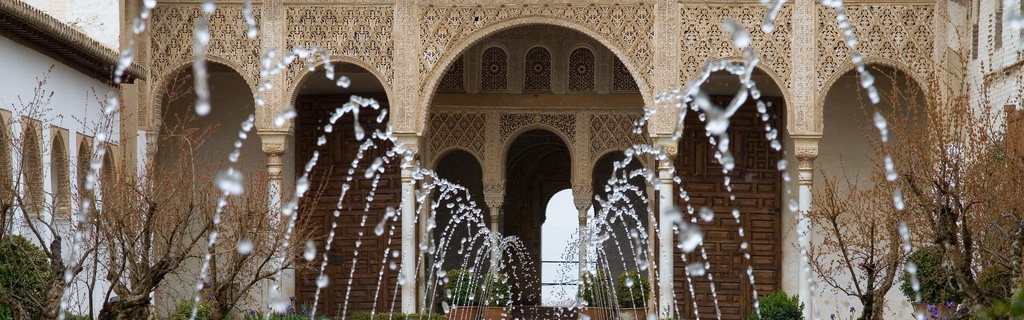 water fountain spouting with alhambra in background
