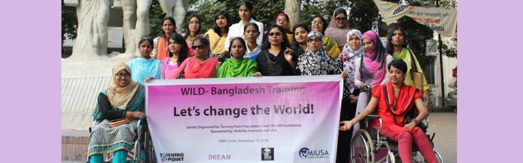 WILD Bangladesh delegates group holding banner