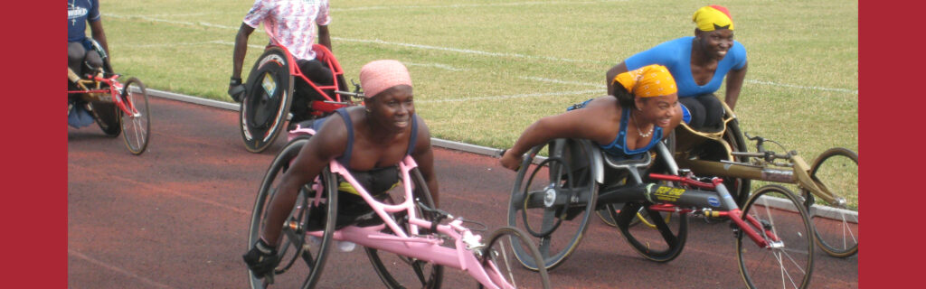 Anjali racing down a track with 2 African women