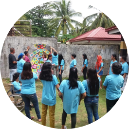 A group of youth participate in a workshop outside.