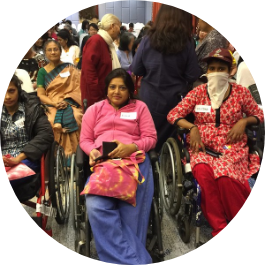 Women with disabilities from South Asia seated in wheelchairs.