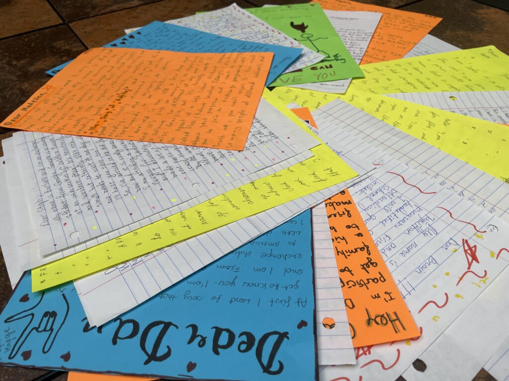 Pile of hand-written letters on a variety of paper