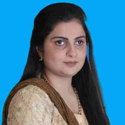 Side portrait of Arisha, she has long black hair and tan blouse with a brown scarf on her shoulder.