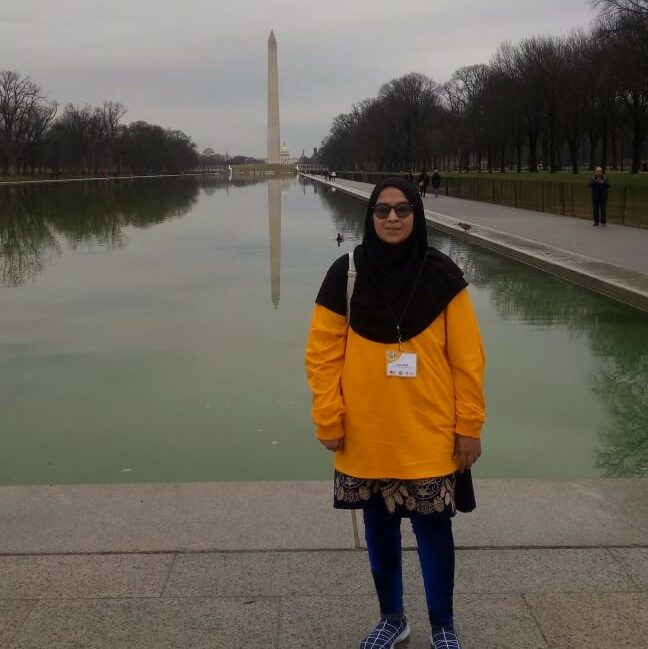 Asma standing in front of Washington, DC Monument pond.