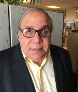 Close up current photo of David Levin in an office, wearing suit jacket