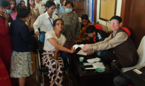 Person with a disability voting during the mock polling activity during the training.