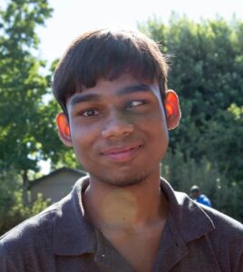 Close up headshot photo of Tanmay smiling.