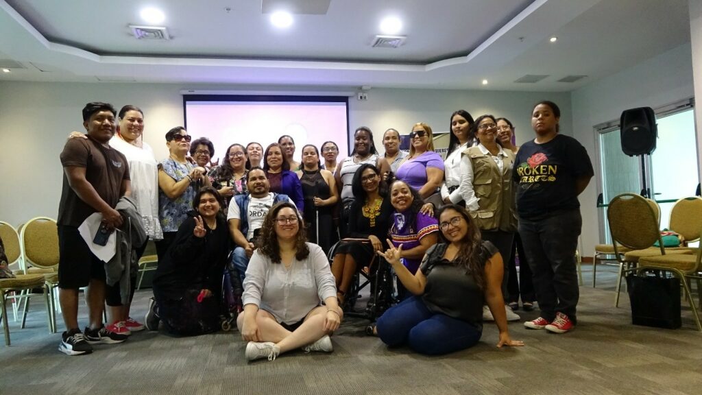 Group photo of 25 workshop participants smiling.