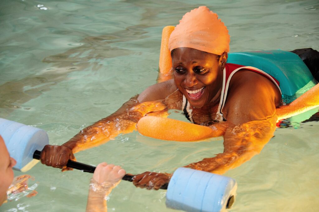Disabled woman swimming in accessible pool