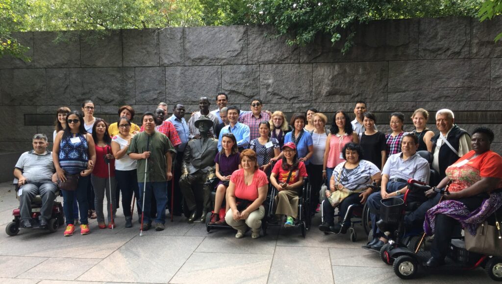 Large group of people with different types of visible disabilities, races, women and men, etc. at the FDR memorial statue in Washington, DC
