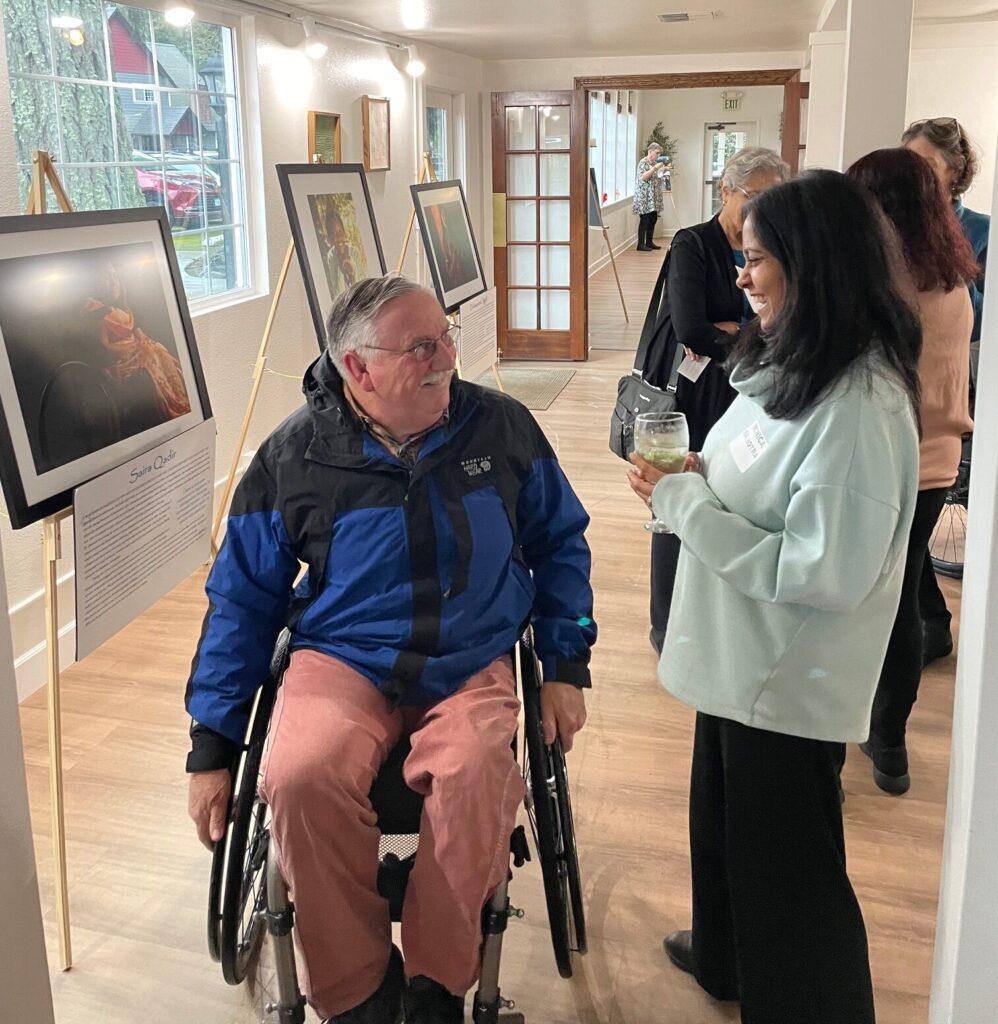Brilliant and Resilient photo exhibit guests mingling at the fundraiser