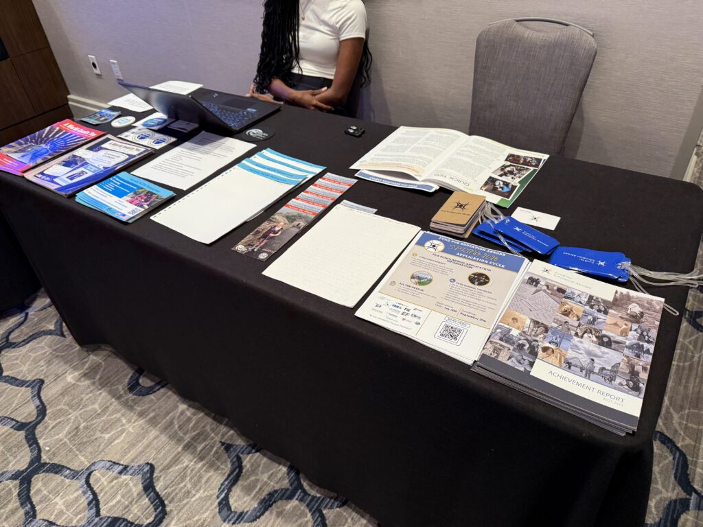 View from above of exhibit table covered in various braille and print materials and brochures