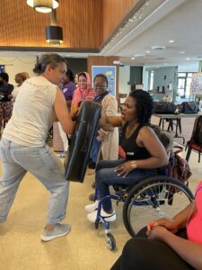 WILD Delegate from Zimbabwe practices self-defense in her wheelchair.