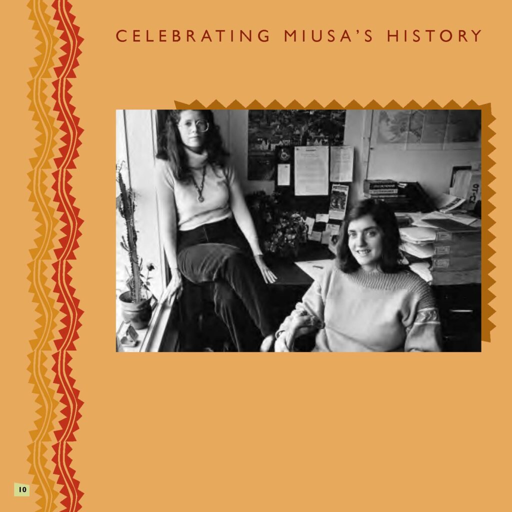 Black and white photo of two women seated in an office, against an orange background with red squiggly line