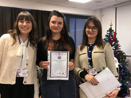 A WILD-Romania participant proudly displays her WILD certificate.